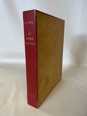 an old red book sitting on top of a white table