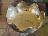 a silver bowl sitting on top of a glass table