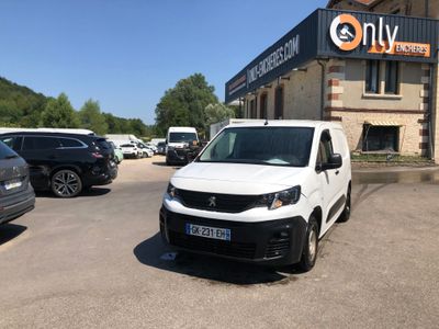 a white van parked in front of a building in a parking lot