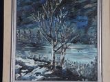 a painting of a tree on a easel in front of a dark blue background