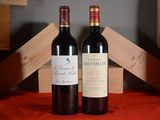 two bottles of red wine sitting next to each other on a table