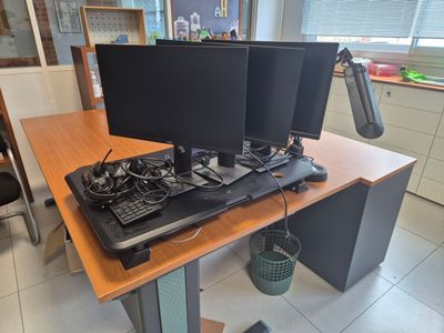 a desk with two computer monitors and a keyboard on it