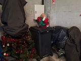 a small christmas tree in the corner of a room