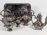 a silver tray with a silver tea set and a silver tea pot