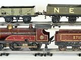 three toy trains on a train track on a white surface