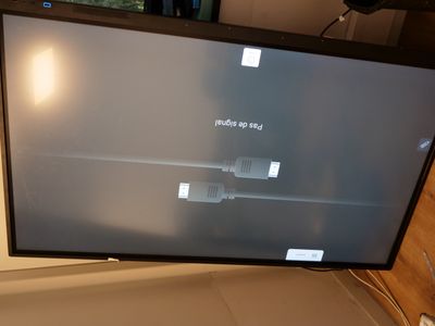 a flat screen tv sitting on top of a desk