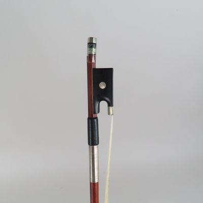 a close up of a violin bow on a wooden stand