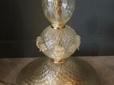 a glass lamp that is sitting on a table