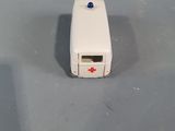 a small white device with a red cross on it