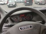 steering wheel of a car with a clock on the dashboard