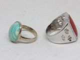 pair of silver rings with turquoise and red stones on them