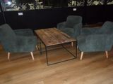 three chairs and a table in the middle of a room