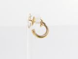 the gold hoop earring has a small white pearl on it