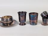 three cups and a saucer sitting on a table