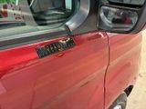 a red truck with a sticker on the side of it ' s door