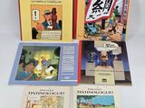 four books on a white surface with chinese characters on them