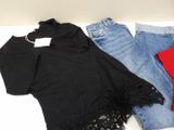 three pairs of jeans and a t - shirt on a table