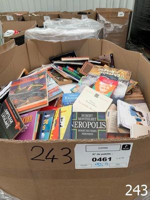 a cardboard box full of books in the middle of a room