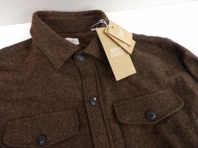 the jacket is brown and has a tag on it