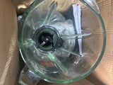 a blender sitting inside of a cardboard box on the floor