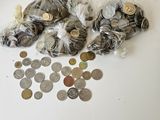 a lot of coins on the table with a bag of them