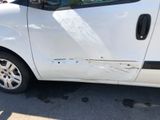 a white van that has been vandalized with a sticker on the side of it