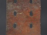 an old wooden box with holes in it on a black background