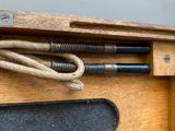 a wooden table with a pair of scissors and a cord attached to it