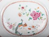 a plate with a peacock and flowers on it