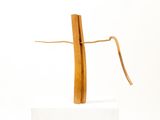 a wooden cross that is on a white surface