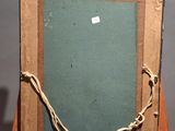 an old wooden easel with a chalk board on top of it