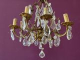 a chandelier hanging from the ceiling in a purple room
