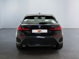 the back of a black bmw car in a white room