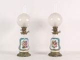 pair of antique porcelain lamps with blue and white flowers on them