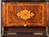 an old wooden box with a decorative design on the inside