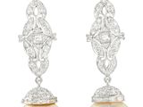 a pair of pearl and diamond earrings