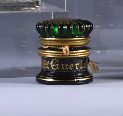 a glass display case with a black and gold container