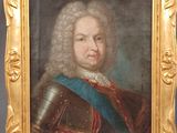 a painting of a man in armor in a gold frame