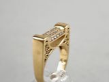 yellow gold ring with diamonds on top of a clear glass