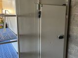 a refrigerator that is sitting in a room with a ladder