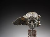 a close up of a statue of an angel on a marble base