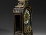 an antique clock with a gold and black decoration on the face