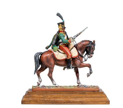 statue of a man on a horse with a sword on a wooden base