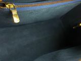 the inside of a black purse with a gold zipper