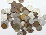a pile of coins sitting on a white surface