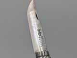 a close up of a knife with a metal handle on top of a table