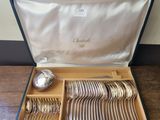 a case with silverware in it on a wooden floor