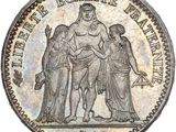 a silver coin with an image of a man and woman on it