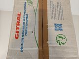 a cardboard box with a green leaf on it sitting on a table