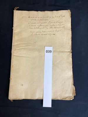 an old piece of paper with writing on it sitting on a table